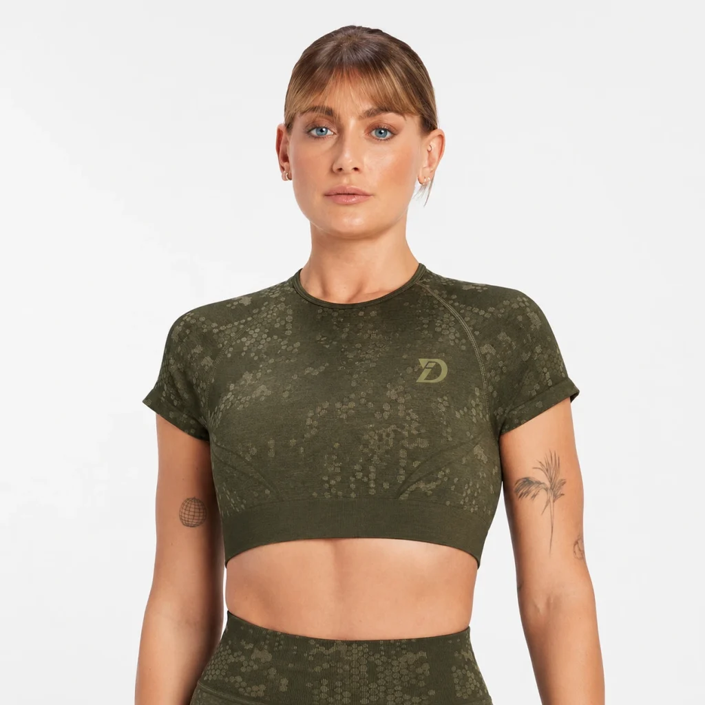 Woman wearing an olive camo short-sleeve athletic crop top with matching high-waisted leggings.